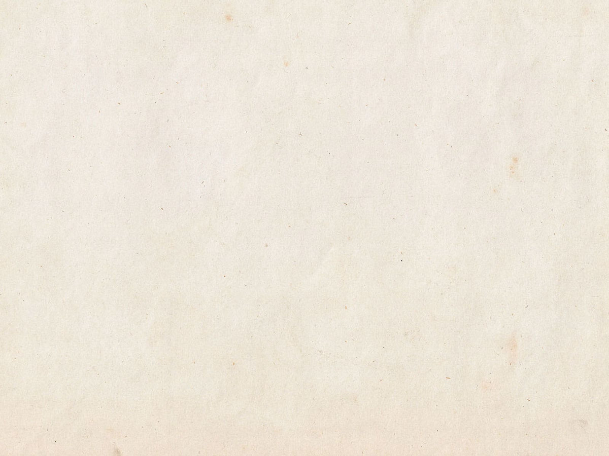 A close-up of a textured, warm off-white or cream paper surface with subtle speckles and a slightly aged tone.